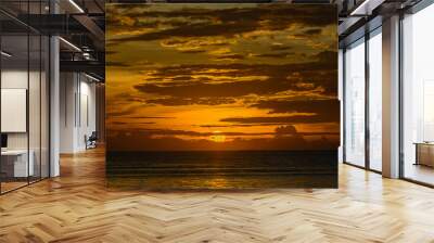 Sunset sky with gold background at te sky line on the sea low key dark theme Wall mural