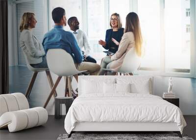 Gathered in the meeting room. Full length shot of a group of corporate colleagues meeting in their office. Wall mural