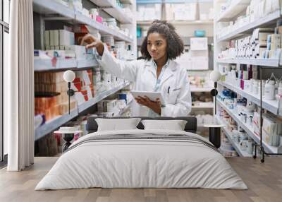 Never fear, your pharmacist is here. Cropped shot of an attractive young female pharmacist working in a pharmacy. Wall mural