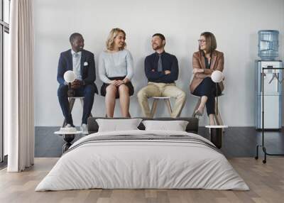 Who will get the job. Studio shot of businesspeople waiting in line against a white background. Wall mural