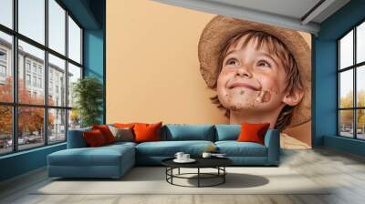 Happy Child with Dirt-Streaked Face in Straw Hat Wall mural