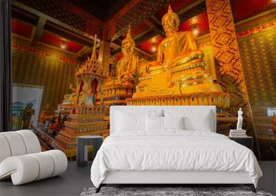 The gold Buddha statue in the temple at Wat Tham Chariya Phirom, Samut Sakhon, Thailand Wall mural