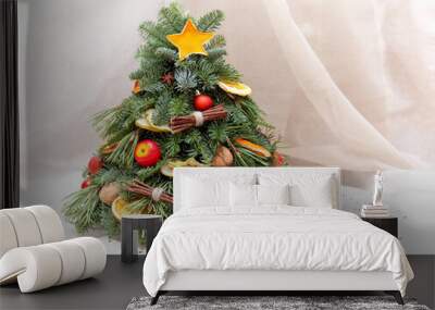 Christmas composition of fir tree branches, orange and apple slices, walnuts, anise and balls Wall mural