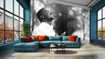 African man praying for thank god with close eye. B&W style Wall mural