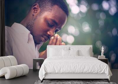 African man praying for thank god.Low key style Wall mural