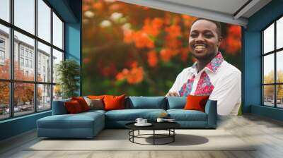 African man wearing native cloth traditional colorful with smile and happy Wall mural