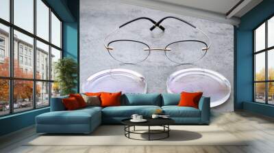 Closeup of fashion trendy eyeglasses lying on table in optical store with new lenses. Professional production, manufacturing and adjust of new glasses lens in optics. Eyewear concept Wall mural