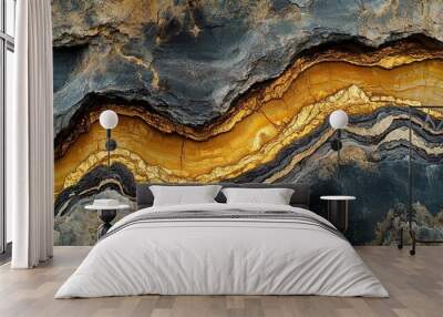 A close-up view of layered rock with golden and black textures. Wall mural