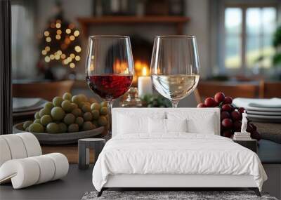 A romantic dinner setting with two glasses of wine, grapes, and a candle on a wooden table. Wall mural