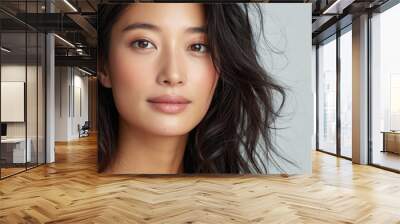 Beautiful confident Asian woman of middle age posing for portrait. Pretty mature adult lady model from Asia looking at camera smiling on background advertising products and services. Close up face . Wall mural