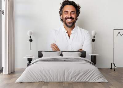 Portrait of a happy latin man with arms crossed against white background Wall mural