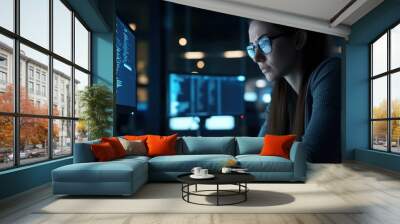 A female IT specialist analyzing digital threats on a computer screen in a dark office soft ambient lighting  ideal for cybersecurity AI and data privacy themes. Wall mural