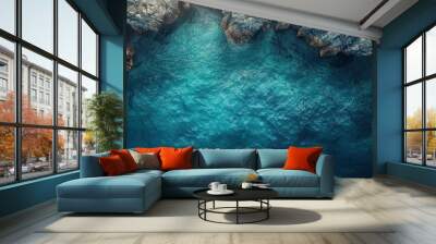 A blue ocean with a rocky shoreline Wall mural