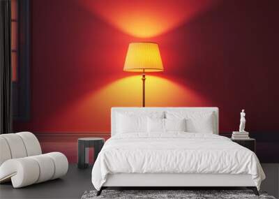 A lamp is lit up in a room with a red wall Wall mural