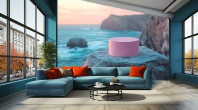 A pink object sits on a rock overlooking the ocean Wall mural