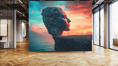 A statue of a woman's face is on a cliff overlooking the ocean Wall mural