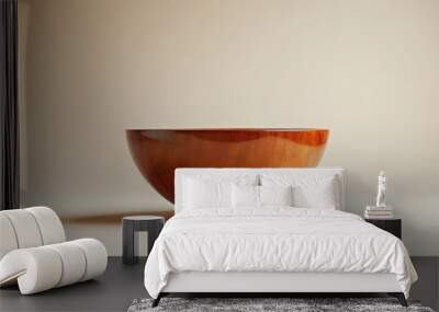 A wooden bowl is sitting on a white background Wall mural