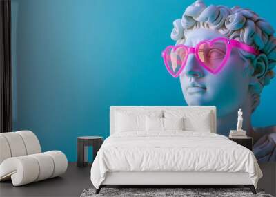 Male antique statue in pink heart shaped sunglasses over blue studio background with copy space, concept of love and Valentine's day Wall mural