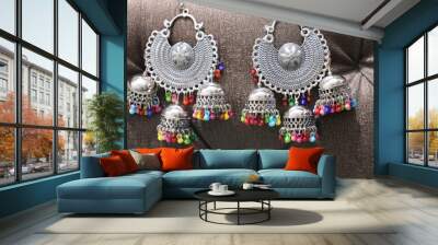 Pair of black metal earring on Black Background Wall mural