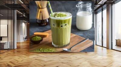  A tall glass of iced matcha latte with almond milk, served with a straw and a sprinkle of matcha powder on top. Wall mural