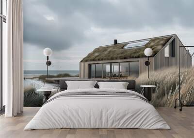 a modern, minimalist beach house surrounded by sand dunes and tall, windswept grasses. The house features large glass windows that allow for an unobstructed view of the beach and ocean Wall mural