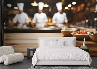 Wooden table with chef cooking in the background. Wall mural