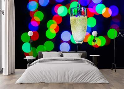 glass full of champagne against christmas lights. Holiday. Party Wall mural