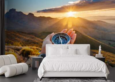 woman hand with magnetic compass in summer mountains at sunrise pov Wall mural