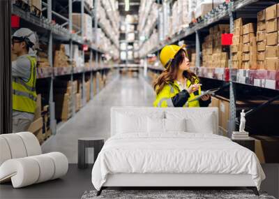 Asian two engineer team shipping order detail on tablet check goods and supplies on shelves with goods background inventory in factory warehouse.logistic industry and business export Wall mural