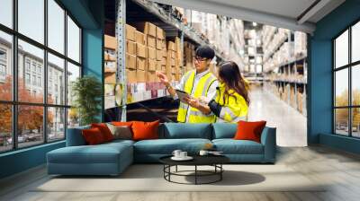 Asian two engineer team shipping order detail on tablet check goods and supplies on shelves with goods background inventory in factory warehouse.logistic industry and business export Wall mural