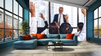 Businessman standing in front of group of people in consulting meeting conference seminar and showing hand to answer question at hall or seminar room.presentation and coaching concept Wall mural