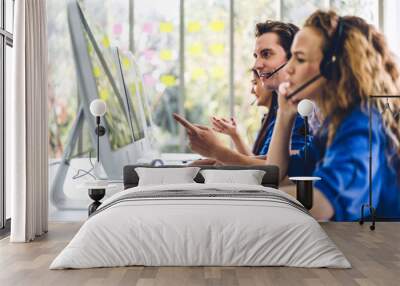 Group of happy call center smiling business operator customer support team phone services agen working and talking with headset on desktop computer at call center Wall mural