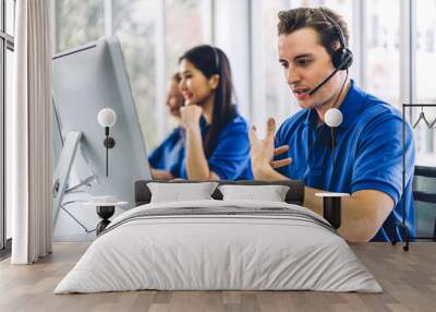 Group of happy call center smiling business operator customer support team phone services agen working and talking with headset on desktop computer at call center Wall mural