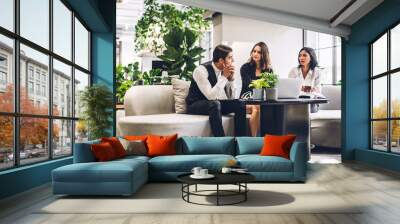 Group of professional business discussing meeting strategy sharing idea with new project.Creative business people working and talk in green plant terrace decorated modern workloft Wall mural