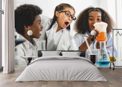 Group of teenage cute little students child learning research and doing a chemical experiment while making analyzing and mixing liquid in test tube at experiment laboratory class at school.Education Wall mural