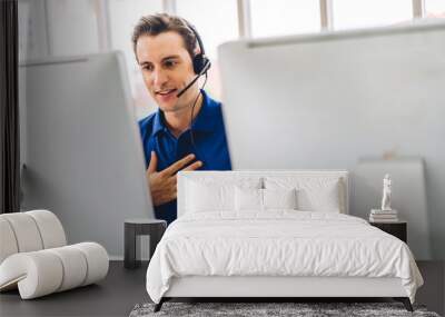 Happy call center smiling businessman operator customer support consult phone services agen working with wireless headset microphone and computer at call center office Wall mural