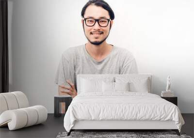 Portrait of a asian young handsome man while standing isiolated on white background Wall mural