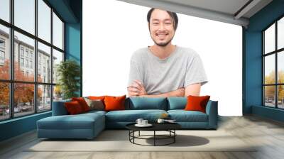 Portrait of a asian young handsome man with arms crossed and smiling while standing isiolated on white background Wall mural