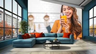 Portrait of beauty body slim healthy asian woman drinking glass of juice and orange.young girl preparing cooking healthy drink with fresh orange juice in kitchen at home.Diet concept.healthy drink Wall mural