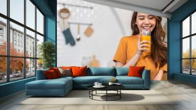 Portrait of beauty body slim healthy asian woman drinking glass of juice and orange.young girl preparing cooking healthy drink with fresh orange juice in kitchen at home.Diet concept.healthy drink Wall mural