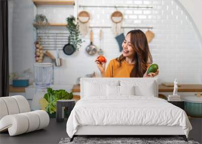 Portrait of beauty body slim healthy asian woman eating vegan food healthy with fresh vegetable salad in kitchen at home.diet, vegetarian, fruit, wellness, health, green food.Fitness and healthy food Wall mural