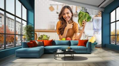 Portrait of beauty body slim healthy asian woman eating vegan food healthy with fresh vegetable salad in kitchen at home.diet, vegetarian, fruit, wellness, health, green food.Fitness and healthy food Wall mural