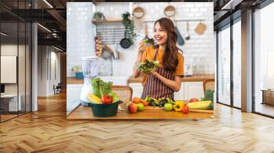 Portrait of beauty body slim healthy asian woman having fun cooking and preparing cooking vegan food healthy eat with fresh vegetable salad on counter in kitchen at home.Diet concept.Fitness, healthy Wall mural