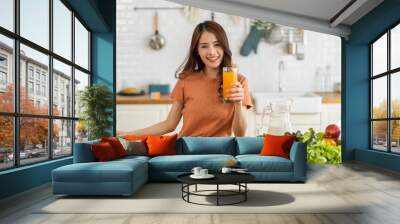 Portrait of beauty healthy asian woman making orange fruit smoothie with blender.girl preparing cooking detox cleanse with fresh orange juice in kitchen at home.health, vitamin c, diet, healthy drink Wall mural