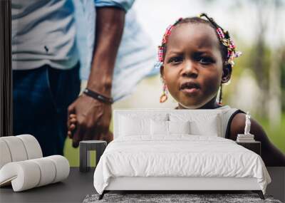 Portrait of enjoy happy love black family african american father holding little african girl hand in moments good time in summer park at home Wall mural