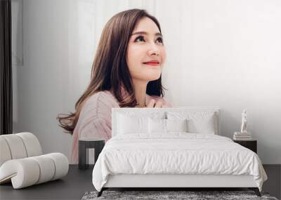 Portrait of happy smile asia woman enjoy and relax on the bed in bedroom at home.asian beauty Wall mural