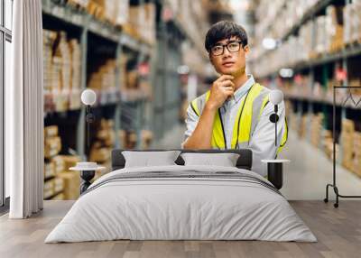 Portrait of smiling asian engineer man order details checking goods and supplies on shelves with goods background in warehouse.logistic and business export Wall mural