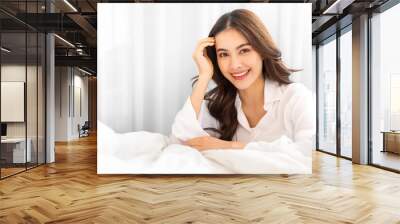 Portrait of smiling cheerful beautiful pretty asian woman clean fresh healthy white skin posing smile in pajamas white clothes.Girl felling relax and enjoy time on the bed at home.asia beauty Wall mural