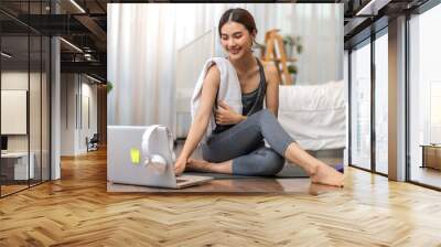 Portrait sport asian beauty body slim woman in sportswear sitting relax and girl practicing yoga and do fitness exercise with laptop computer in bedroom at home.Diet concept.Fitness and healthy Wall mural