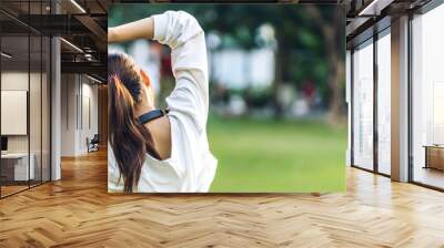 Portrait sport asian beauty body slim woman warming up in sportswear relax and do fitness exercise with stretching workout before fitness training in park.Diet concept.Fitness and healthy Wall mural